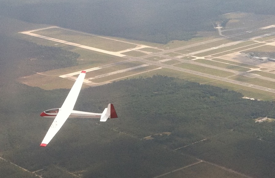A glider circling gracefully just east of Cecil Airport.