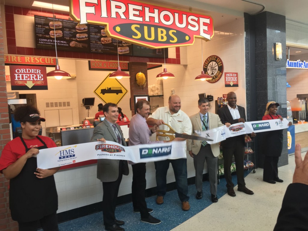 HMS Host VP of Business Development Stephen Douglas, Firehouse Subs Founders Chris & Robin Sorensen, JAA Board Chairman Patrick Kilbane and Denard Enterprises President Frank Johnson  officially open the JAX Airport Firehouse Subs Location for Business. 